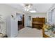 Versatile living space featuring tile flooring, ceiling fan, and access to a storage room, perfect for flexible living at 4432 E Carmel Ave, Mesa, AZ 85206