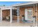 Cozy outdoor patio with seating, a tiled floor, a brick privacy wall, and a charming pergola for shade at 4432 E Carmel Ave, Mesa, AZ 85206