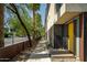 Modern home's entryway with a bright yellow door, clean lines and a sidewalk on a sunny day at 4507 N 12Th St # 6, Phoenix, AZ 85014