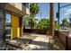 View of the modern home's entrance with a yellow door and desert landscaping at 4507 N 12Th St # 6, Phoenix, AZ 85014