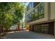 Modern home exterior featuring a large garage door and contemporary architectural design surrounded by lush trees at 4507 N 12Th St # 6, Phoenix, AZ 85014