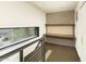 Hallway with a built-in desk, concrete wall, and a large horizontal window offering bright natural light at 4507 N 12Th St # 6, Phoenix, AZ 85014