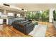 Open concept living room with a large window, wood floors, modern kitchen and comfortable seating at 4507 N 12Th St # 6, Phoenix, AZ 85014