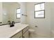 Bathroom features a gray vanity, white countertop, matte black fixtures, and marble-look tile flooring at 4946 W Weeping Willow Way, Laveen, AZ 85339