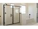 Stylish bathroom boasting a glass-enclosed shower and a soaking tub at 4946 W Weeping Willow Way, Laveen, AZ 85339