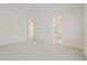 Spacious bedroom featuring neutral carpet, an ensuite bath and an open door at 4946 W Weeping Willow Way, Laveen, AZ 85339