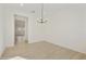 Bright dining room featuring light wood floors and a modern chandelier at 4946 W Weeping Willow Way, Laveen, AZ 85339
