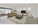 Cozy living room with modern furnishings, large windows, and a sliding glass door for natural light at 4946 W Weeping Willow Way, Laveen, AZ 85339