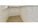 Walk-in closet with built in shelves and carpet flooring at 4946 W Weeping Willow Way, Laveen, AZ 85339
