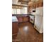 Kitchen features laminate countertops, wood cabinets, and white appliances at 5220 E Winchcomb Dr, Scottsdale, AZ 85254