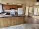 An outdated kitchen with laminate countertops and a breakfast bar connecting to the living area at 5220 E Winchcomb Dr, Scottsdale, AZ 85254