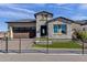 Charming single-Gathering home with stone accents, beautiful landscaping, and a dark brown garage at 5748 E Sierra Morena St, Mesa, AZ 85215