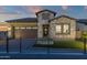 Charming single-Gathering home featuring stone accents, a dark brown garage, and brick paved driveway at 5748 E Sierra Morena St, Mesa, AZ 85215