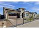 Charming single-Gathering home featuring stone accents, a dark brown garage, and brick paved driveway at 5748 E Sierra Morena St, Mesa, AZ 85215
