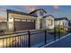 Charming single-Gathering home featuring stone accents, a dark brown garage, and brick paved driveway at 5748 E Sierra Morena St, Mesa, AZ 85215