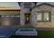 Beautiful single-Gathering home showing stone detail and a well manicured lawn at 5748 E Sierra Morena St, Mesa, AZ 85215