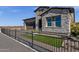 Beautiful single-Gathering home featuring stone accents, a dark brown garage, and manicured landscaping at 5748 E Sierra Morena St, Mesa, AZ 85215