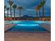 Community pool with lounge seating surrounded by palm trees at 5748 E Sierra Morena St, Mesa, AZ 85215