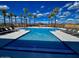 A pristine community swimming pool lined with palm trees, perfect for relaxation at 5748 E Sierra Morena St, Mesa, AZ 85215