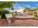 Outdoor kitchen and patio area featuring a built-in grill, brick flooring, and in-ground pool at 5801 E Exeter Blvd, Phoenix, AZ 85018