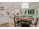 Dining room with a round table, black chairs, and a view of the adjacent kitchen and outdoor scenery at 5801 E Exeter Blvd, Phoenix, AZ 85018