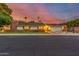 Charming single-story home featuring a brick exterior, a well-manicured lawn, and a two car garage at 5801 E Exeter Blvd, Phoenix, AZ 85018