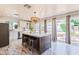 Bright kitchen with stainless appliances, white cabinets, a center island, and access to the backyard at 5801 E Exeter Blvd, Phoenix, AZ 85018