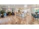 Open-concept living space with a modern kitchen, cozy seating area, fireplace, and hardwood floors at 5801 E Exeter Blvd, Phoenix, AZ 85018