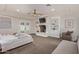 Spacious bedroom with a fireplace, built-in shelving, a tray ceiling and access to a private outdoor space at 5801 E Exeter Blvd, Phoenix, AZ 85018