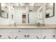 Bathroom features double sinks, white cabinetry, and mirrors above the vanity at 6235 N 25Th Ave, Phoenix, AZ 85015