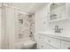 This updated bathroom features a shower over the tub with marble tile at 6235 N 25Th Ave, Phoenix, AZ 85015
