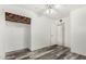 This cozy bedroom features wood-look floors, an open closet, and a ceiling fan at 6235 N 25Th Ave, Phoenix, AZ 85015