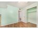 Bedroom has laminate flooring, an open closet, and an ensuite bath at 6235 N 25Th Ave, Phoenix, AZ 85015