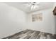 Minimalist bedroom showcasing sleek laminate flooring, bright white walls, and a central window at 6235 N 25Th Ave, Phoenix, AZ 85015