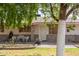 Inviting single-story house featuring a decorative security door, manicured lawn, and mature trees at 6235 N 25Th Ave, Phoenix, AZ 85015