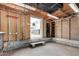 Unfinished garage with block walls, concrete floor and exposed rafters leads to large fenced backyard at 6235 N 25Th Ave, Phoenix, AZ 85015