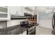 A close view of stainless steel oven and black granite countertop, adjacent to a kitchen at 6235 N 25Th Ave, Phoenix, AZ 85015