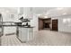 Bright kitchen with white cabinetry, granite countertops, and stainless steel appliances, next to brick fireplace at 6235 N 25Th Ave, Phoenix, AZ 85015