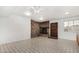Cozy living room featuring a brick fireplace, ceiling fan, and tile flooring at 6235 N 25Th Ave, Phoenix, AZ 85015