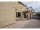 Exterior view of a home with a large backyard featuring a covered patio and paver flooring at 6853 E Posada Cir, Mesa, AZ 85212
