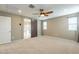 Bright bedroom with barn door to bathroom, neutral walls, carpet floors and lots of light at 6853 E Posada Cir, Mesa, AZ 85212