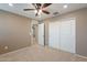 Neutral bedroom featuring carpet floors, ceiling fan and sliding closet doors at 6853 E Posada Cir, Mesa, AZ 85212