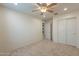 Neutral bedroom featuring carpet floors, ceiling fan and sliding closet doors at 6853 E Posada Cir, Mesa, AZ 85212