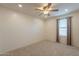 Bright bedroom with neutral walls, carpet floors and a window with curtains at 6853 E Posada Cir, Mesa, AZ 85212