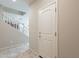 Hallway showcasing tile flooring, a staircase to the second floor, and neutral wall paint at 6853 E Posada Cir, Mesa, AZ 85212