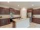 Well-lit kitchen with stainless steel appliances, island, and ample cabinet space at 6853 E Posada Cir, Mesa, AZ 85212