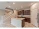 Modern kitchen featuring an island, stainless appliances, and seamless access to the staircase at 6853 E Posada Cir, Mesa, AZ 85212