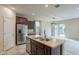 Bright kitchen boasts stainless appliances and an island, seamlessly transitioning to the living area at 6853 E Posada Cir, Mesa, AZ 85212