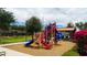 Community playground with modern red and blue play structure and shade for hot days at 6853 E Posada Cir, Mesa, AZ 85212