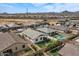 Aerial view showcases home's backyard oasis with pool and green space at 730 W Wind Cave Dr, San Tan Valley, AZ 85140